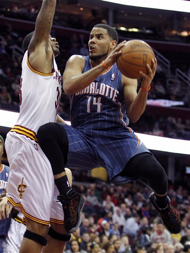 Charlotte Bobcats' D.J. Augustin (14) puts up a shot against Cleveland Cavaliers' Alonzo Gee in the first quarter during an NBA basketball game Tuesday April 5, 2011, in Cleveland. 