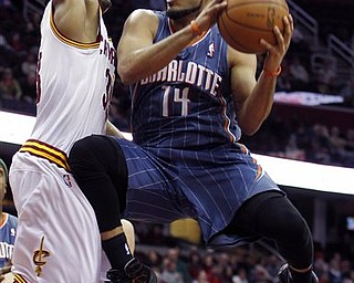 Charlotte Bobcats' D.J. Augustin (14) puts up a shot against Cleveland Cavaliers' Alonzo Gee in the first quarter during an NBA basketball game Tuesday April 5, 2011, in Cleveland.