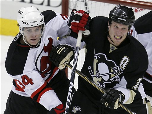 Pittsburgh Penguins' Jordan Staal, right, and New Jersey Devils' Mark Fayne work for position in from of Devils goalie Johan Hedberg of Sweden during the first period of an NHL hockey game in Pittsburgh Tuesday, April 5, 2011.