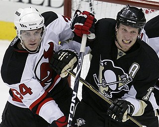 Pittsburgh Penguins' Jordan Staal, right, and New Jersey Devils' Mark Fayne work for position in from of Devils goalie Johan Hedberg of Sweden during the first period of an NHL hockey game in Pittsburgh Tuesday, April 5, 2011.