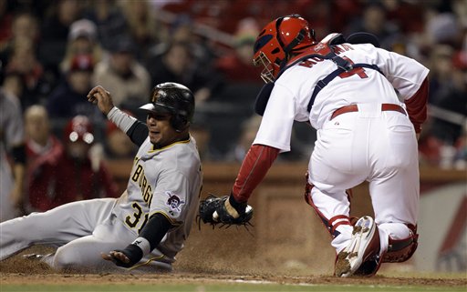 Pittsburgh Pirates' Jose Tabata, left, is tagged out at home by St. Louis Cardinals catcher Yadier Molina during the eighth inning of a baseball game Monday, April 4, 2011, in St. Louis.
