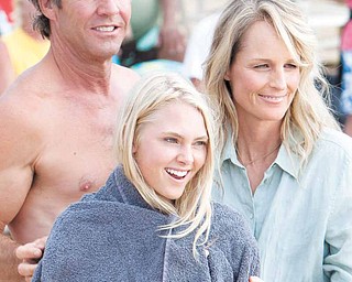 In this film publicity image released by TriStar Pictures, Dennis Quaid, AnnaSophia Robb, center, and Helen Hunt are shown in a scene from "Soul Surfer." (AP Photo/TriStar Pictures, Mario Perez)