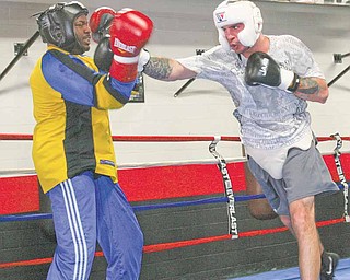 Kelly Pavlik spars with Romaro Johnson during a conditioning session Thursday at the Southside Boxing Club. Pavlik is training for his upcoming bout with Alfonso Lopez on May 7 in Las Vegas. It will be the first time Pavlik will be back in the ring since losing his middleweight title to Sergio Martinez almost a year ago.
