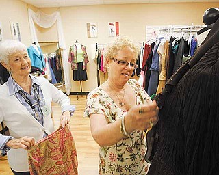 Rhonda Daily (right) looks at clothes in the boutique section while talking to volunteer Ida Lake at Hillcrest Thrift Shop in Kansas City, Missouri. Thrift stores are now starting to resemble regular retail locations. (Garvey Scott/Kansas City Star/MCT)