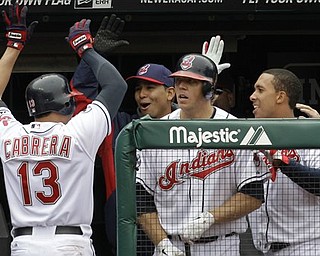 Cleveland Indians' Asdrubal Cabrera (13) is congratulated in the dugout in the eighth inning in a baseball game against the Boston Red Sox, Thursday, April 7, 2011, in Cleveland. Cabrera's suicide-squeeze bunt put the Indians ahead in their fourth straight victory, scoring Adam Everett. The Indians swept the series and won 1-0. (AP Photo/Tony Dejak)
