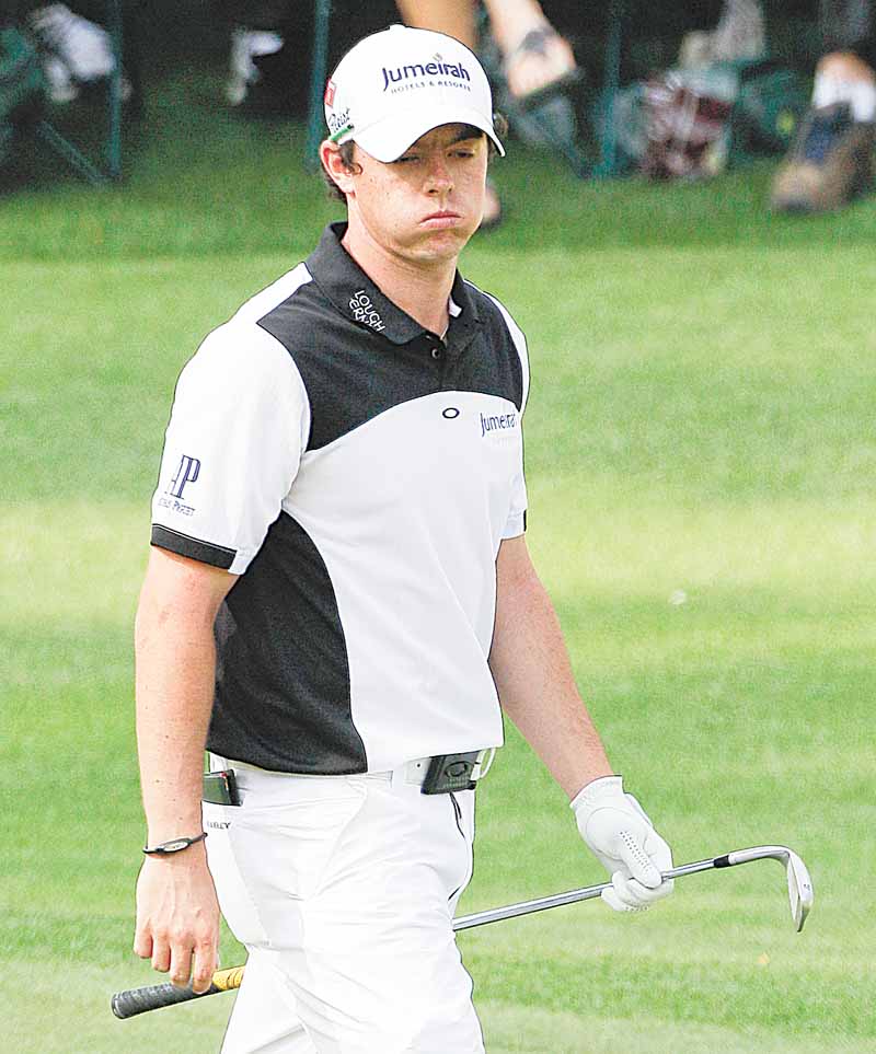 Rory McIlroy of Northern Ireland reacts to his shot that nearly rolled in the water on the 15th hole during the second round of the Masters golf tournament Friday, April 8, 2011, in Augusta, Ga. (AP Photo/David J. Phillip)
