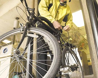 Paul Kobulnicky of Poland, a librarian at Youngstown State University’s William F. Maag Library, gets ready to ride his bicycle. The city of Youngstown has a new map to show riders the easiest, moderate and hardest bicycle routes through city streets.