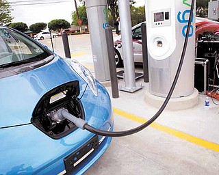 A Nissan Leaf is charged during a demo at the first ever quick charge electric vehicle charging station in the state of Texas, located at the Walgreens at Beltline and Monfort, which was unveiled in Dallas on Friday, April 8, 2011. It is one of dozens of new stations NRG Energy Inc. and others are planing for Dallas and Houston.