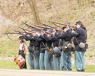 Members of the Western Pennsylvania Civil War Reenactors Society fire their rifl es during a spring drill Saturday afternoon at the Raisch Log Cabin in Sharpsville Community Park in Sharpsville, Pa.
