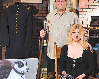 Marcus McLemore of Poland stands with his fi ancee, Bethany Ann Lettau, among their collection of Civil War
memorabilia.