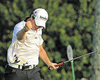 Rory McIlroy of Northern Ireland reacts after making a birdie putt on the 17th hole during the third round of the Masters golf tournament Saturday, April 9, 2011, in Augusta, Ga.