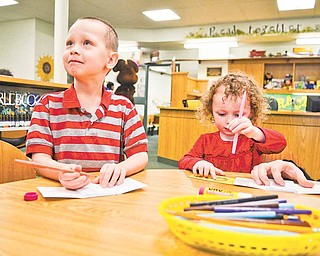 Brody Cheney, 5, and his sister, Noelle, 3, create “All About Me” books at a craft table in the children’s room at Hubbard Public Library, 436 W. Liberty St., Hubbard. The library hosted an open house Sunday afternoon, and about 200 people attended.