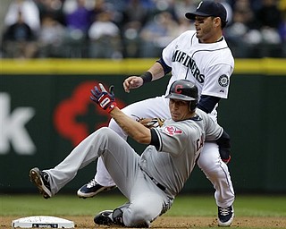 Seattle Mariners second baseman Adam Kennedy, right, becomes tangled with Cleveland Indians' Asdrubal Cabrera after Kennedy tagged out Cabrera at second base in the first inning of a baseball game Sunday, April 10, 2011, in Seattle. Cabrera singled in a run on the play, but was caught at second base.