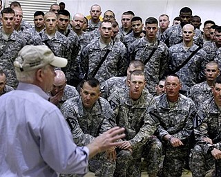 Defense Secretary Robert Gates speaks with from soldiers from the 4th Advise and Assist Brigade, 1st Calvalry Division out of Fort Hood, Texas, while visiting Camp Marez in Mosul, Iraq, Friday, April 8, 2011.