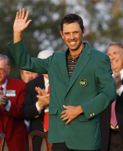Charl Schwartzel of South Africa waves with his green jacket after winning the Masters championship golf tournament Sunday, April 10, 2011, in Augusta, Ga. 