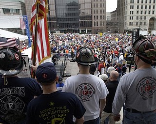 Firefighters stand on the Ohio Statehouse steps as protestors against Ohio's new state law that curtails the collective bargaining rights of more than 350,000 public workers gather for a rally launching the We Are Ohio campaign Saturday, April 9, 2011, in Columbus, Ohio. The We Are Ohio campaign, which bills itself as a grass-roots, bipartisan group, is signing up people to circulate petitions in pursuit of a referendum on the measure.