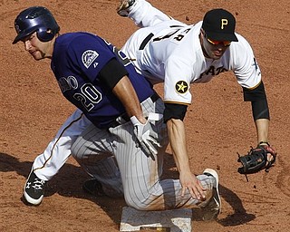 Colorado Rockies' Chris Iannetta (20) takes Pittsburgh Pirates second baseman Neil Walker out of the double play after being forced out at second on a seventh inning fielder's choice by Rockies' Ryan Spilborghs during a baseball game in Pittsburgh, Sunday, April 10, 2011. The Rockies won 6-5.