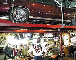 Bowman, of Cornersburg, admires his 1967 Chevy Chevelle, on display at Quaker Steak & Lube through April. Bowman bought the car for $1,800 in 1988 and recently finished rebuilding it a second time. “When you’re out in the sun, it’s really bright and brilliant,” Bowman said of his car.