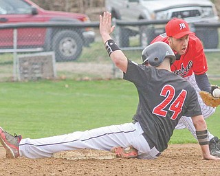 Girard baserunner A.J. Weibel takes third base as Campbell infielder Brandon Reyes fields the throw during the Indians’ 12-1 win.