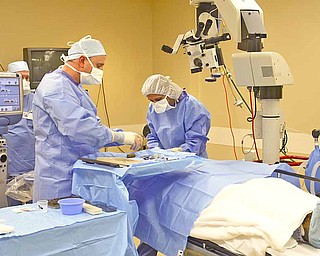 Dr. Sergul Erzurum of Eye Care Associates, prepares cataract surgery patient Ronald Zingaro's eyes before the operation. Dr. Erzurum provided free cataract surgery to 13 patients on March 8 through Eye Care Associates’ Mission Cataracts.