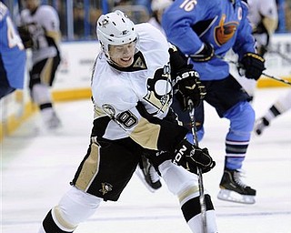Pittsburgh Penguins center Tyler Kennedy (48) shoots in front of Atlanta Thrashers left wing Andrew Ladd, right, during the first period of an NHL hockey game Sunday, April 10, 2011, in Atlanta. Pittsburgh won 5-2.