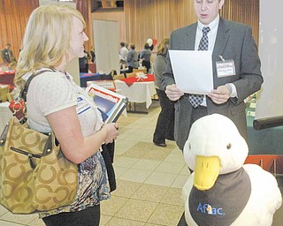 Youngstown State University student Jackie Rager of Struthers talks with Afl ac recruiter Matthew White at Tuesday’s job expo at Kilcawley Center on campus. Rager was one of more than 200 students who attended the event, and many students said they felt good about their chances at landing employment.