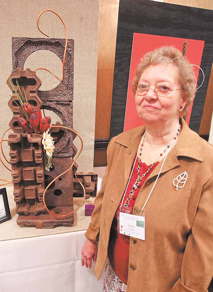 More than 175 attended the Garden Club of Ohio’s convention Tuesday in Boardman. Sheila Bowman stands next to the overall winner, submitted by the Center of Industry and Labor.
