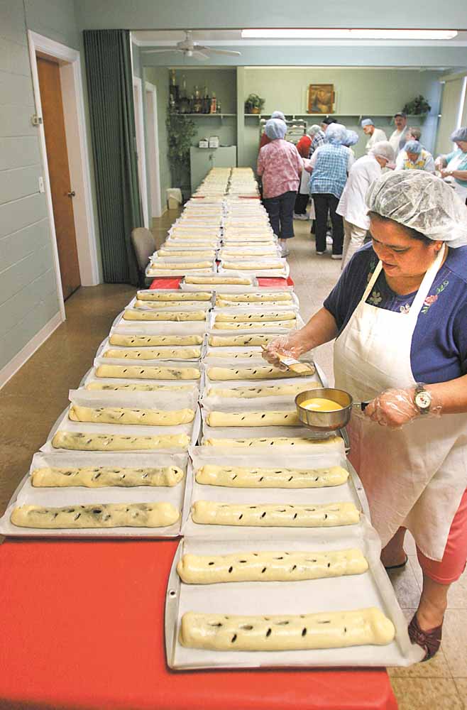 Belinda Jauregui helps to butter more than 300 rolls of kolachi that members of the Christian Women’s Connection at Simon Road Church of God in Boardman made Tuesday morning. The kolachi are sold to benefit the church, the women’s group and other organizations. There will be another sale from 2 p.m. to 4 p.m. Thursday at the church, 4750 Simon Road.