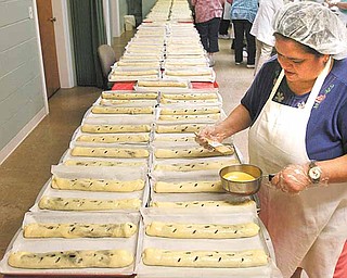 Belinda Jauregui helps to butter more than 300 rolls of kolachi that members of the Christian Women’s Connection at Simon Road Church of God in Boardman made Tuesday morning. The kolachi are sold to benefit the church, the women’s group and other organizations. There will be another sale from 2 p.m. to 4 p.m. Thursday at the church, 4750 Simon Road.