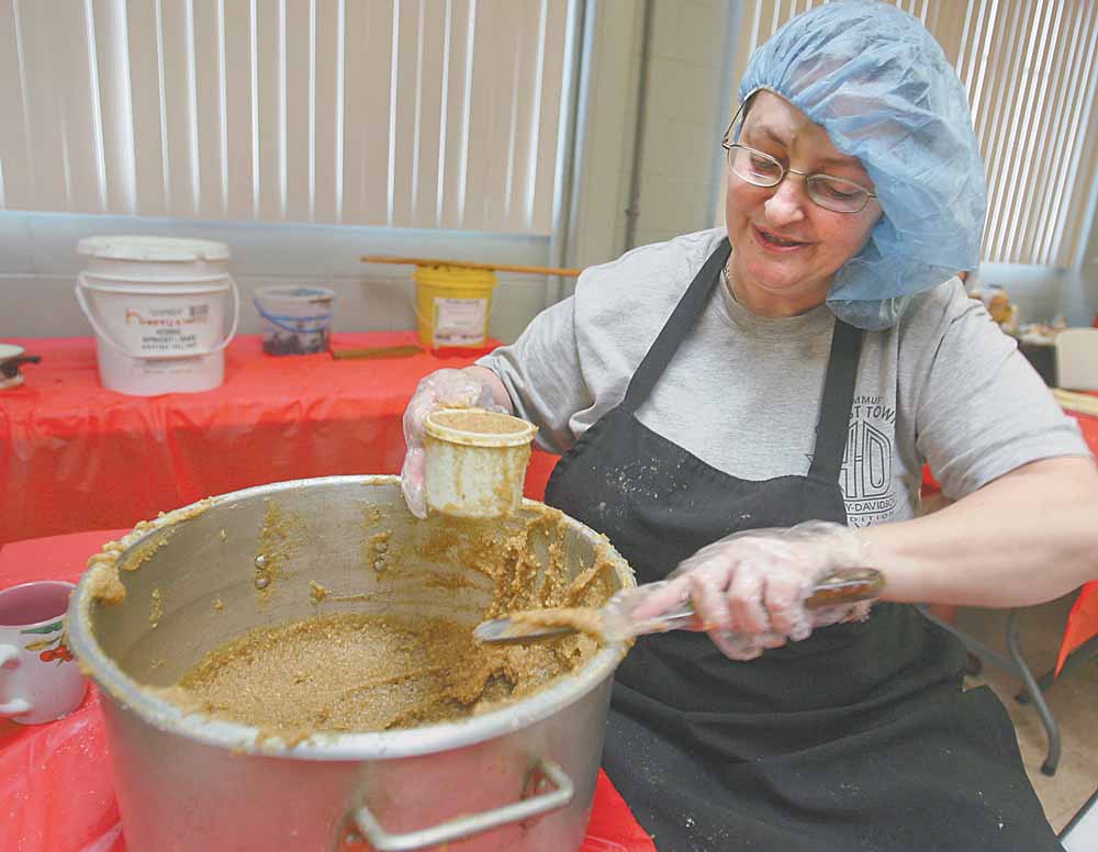 Dina Reeves measures the right amount of nut mix for the kolachi.  The sweet bread rolls made by a church women’s group in Boardman come in four varieties of fillings.  