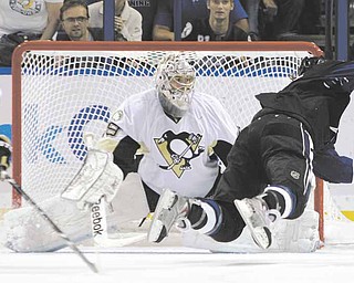 Tampa Bay Lightning left wing Ryan Malone, right, flies through the air after getting tripped by Pittsburgh Penguins left wing Mike Rupp (17) in front of Penguins goaltender Marc-Andre Fleury (29) during the third period of an NHL hockey game Thursday, March 31, 2011 in Tampa, Fla. Rupp drew a two-minute penalty for tripping. The Lightning won 2-1.