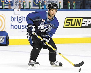Tampa Bay Lightning right wing Martin St. Louis stick handles during hockey practice for their first-round NHL playoff series against the Pittsburgh Penguins Tuesday, April 12, 2011 in Tampa, Fla. Game One of the best-of-seven series begins Wednesday night in Pittsburgh.