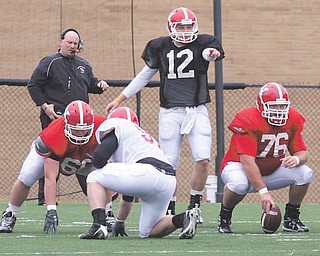 FOOTBALL - (12) Kurt Hess directs the offense Saturday morning at YSU. - Special to The Vindicator/Nick Mays