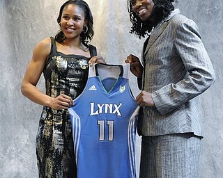Connecticut's Maya Moore, left, and Xavier's Amber Harris, right, hold up a Minnesota Lynx jersey after being picked by the team in the WNBA basketball draft in Bristol, Conn., Monday, April 11, 2011. 