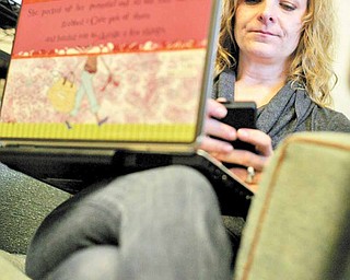 Kristen Cullen, of West Bloomfield, uses her laptop and smart phone to keep in communication with her husband Niall's doctors at the Karmanos Cancer Center in Detroit, Michigan, March 15, 2011. Cullen has been her husband's caregiver since he was diagnosed with colon cancer three years ago. (Andre J. Jackson/Detroit Free Press/MCT)