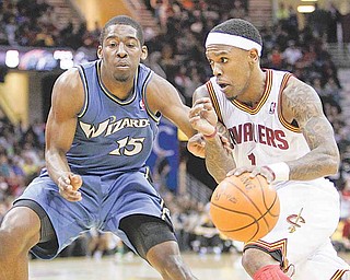 Cleveland Cavaliers' Daniel Gibson, right, drives on Washington Wizards' Jordan Crawford (15) in the first quarter of an NBA basketball game Wednesday, April 13, 2011, in Cleveland. (AP Photo/Mark Duncan)