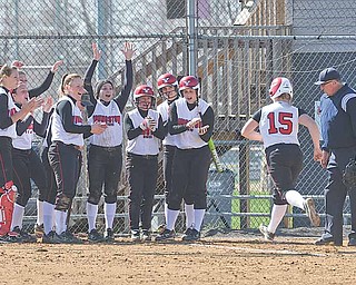 Youngstown State's Vicky Rumph runs to home as her teammates wait and congratulate her during the first game of a doubleheader against the Detroit Titans at McCune Park in Canfield.