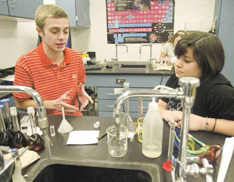 Students Vince DeChellis and Becca Mowad work together in their 11th grade chemistry class at Poland Seminary High School. The two are earning credit toward their college degrees in a program called College in High School.