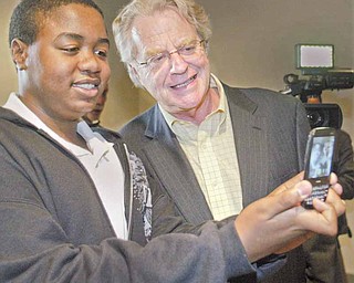 Oscar Aslam, 14, of Austintown snaps a photo of himself with TV talk-show host and former Cincinnati Mayor Jerry Springer during the Mahoning County Dem-ocratic Party Hall of Fame dinner at Mr. Anthony’s in Boardman on Thursday. Springer was the guest speaker.