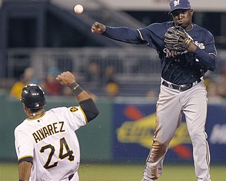 Milwaukee Brewers shortstop Yuniesky Betancourt throws to first after forcing out Pittsburgh Pirates' Pedro Alvarez (24) on the front half of a double play Ryan Doumit hit into in the seventh inning of a baseball game Wednesday, April 13, 2011, in Pittsburgh. The Brewers won 6-0. (AP Photo/Keith Srakocic)