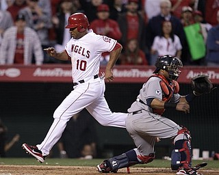 Los Angeles Angels' Vernon Wells (10) scores on a sacrifice by teammate Jeff Mathis to win a baseball game against the Cleveland Indians in the 12th inning in Anaheim, Calif., Wednesday, April 13, 2011. The Angels won 4-3. (AP Photo/Jae C. Hong)