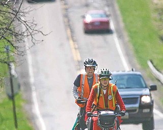 Lee “Shiloh” Pickering, 61, left, and his wife, Ruthie, 33, of Portland, Ore., travel through Youngstown. They stopped here Friday to visit a relative. They hope to be in Connecticut on May 1. They started their bicycle trip in their hometown Oct. 27, 2010.