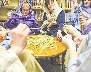 Women of First Christian Church (Disciples of Christ) take a break from a recent rehearsal of the drama, “It Is Finished,” to make palm crosses. The crosses will be distributed at performances scheduled today, Palm Sunday, and Maundy Thursday. A musical interlude will be 6:45 p.m. and the presentation at 7 both days at the church, 33 N. Arlington Ave., Niles.