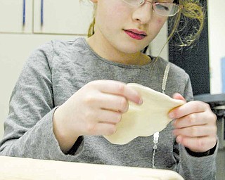 Anna Kan prepares matza dough.