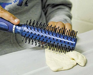 William d Lewis The Vindicator A hair brush( brand new that never brushed hair) is used to make holes in matza dough at Akiva Academy.