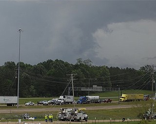 Storms continue to brew as I-20 is shut down after a morning tornado downed power lines and overturned cars and trucks Friday, April 15, 2011 in Clinton, Miss. A state of emergency has been declared for 14 Mississippi counties after spring storms swept across the state, spawning suspected tornadoes that left many homes and businesses destroyed and at least three people critically injured. AP Photo/The Clarioni-Ledger, Brian Albert Broom)