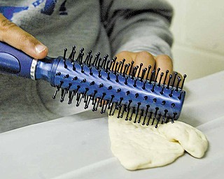 A brand-new hairbrush punctures small holes in matzah dough to curtail the leavening process. 