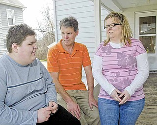 Sean Barron, center, shares his experiences of growing up with autism with Derrick Lind of Struthers, left, and Derrick’s mother, Chrissy.