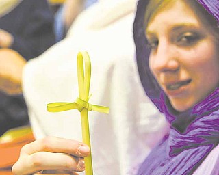 Savanna Cross, 12, of Niles shows a palm cross she made. She is a cast member of “It Is Finished,” a story of the last days of Jesus. Palm crosses will be distributed to members of the audience who attend the drama at First Christian Church in Niles.