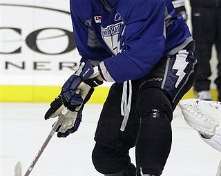 Tampa Bay Lightning center Steven Stamkos attempts to deflect a puck during hockey practice for their first-round NHL playoff series against the Pittsburgh Penguins Tuesday, April 12, 2011 in Tampa, Fla.  Game One of the best-of-seven series begins Wednesday night in Pittsburgh. 